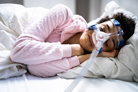 woman sleeping with cpap